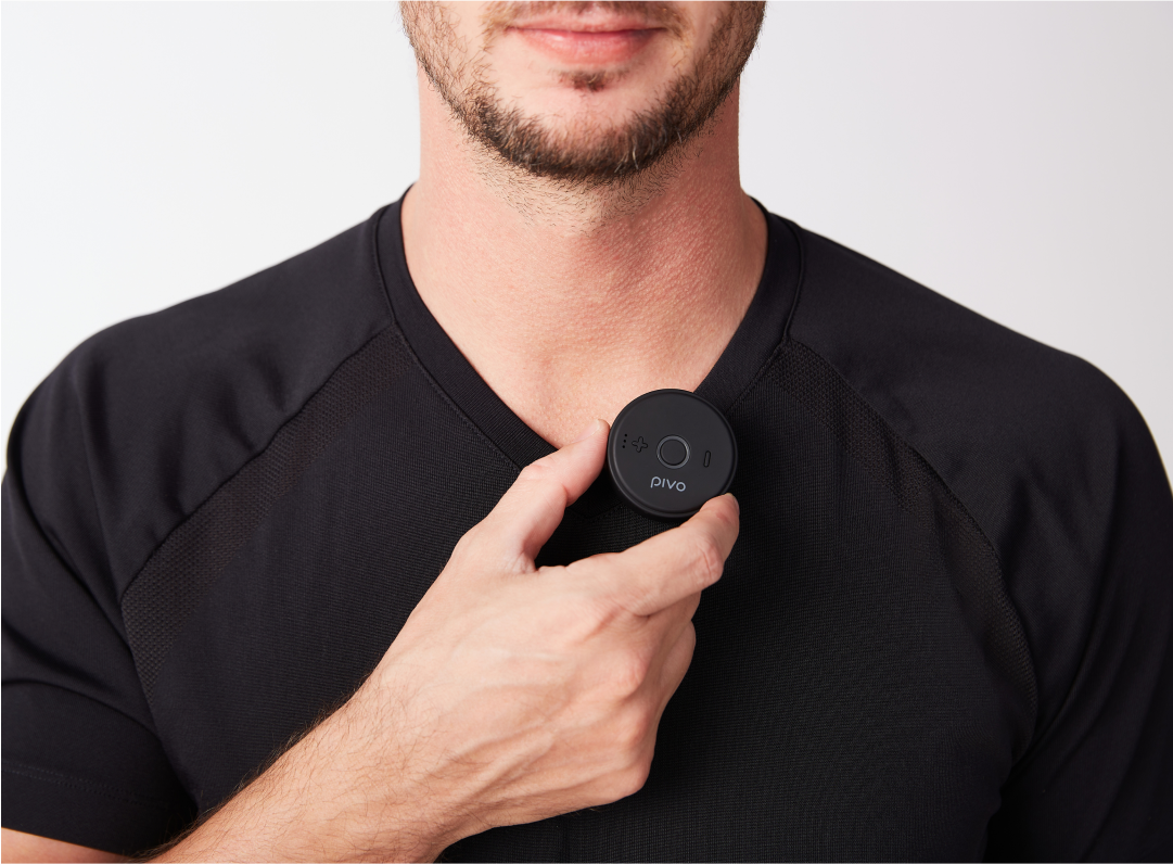 Compact wireless Bluetooth mic clipped onto a person's shirt.
