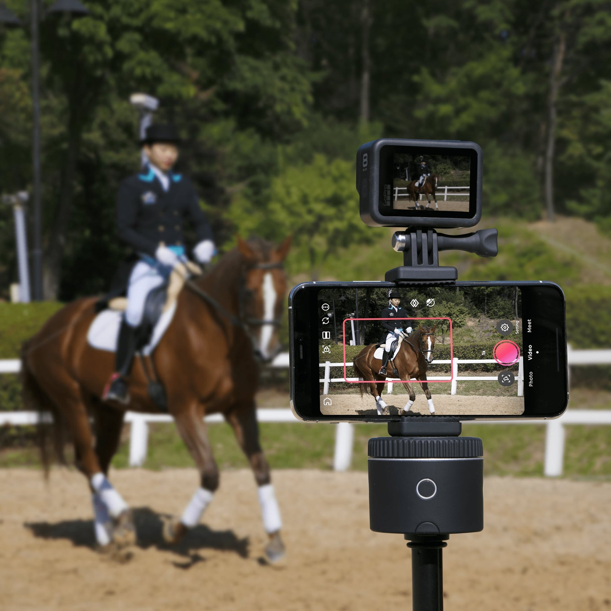 Pivo Action Mount attached to smartphone and camera on a Pivo Pod, capturing equestrian scene.